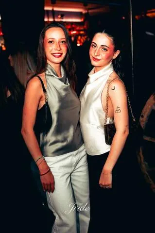 Due amiche vestite in bianco e nero in posa insieme